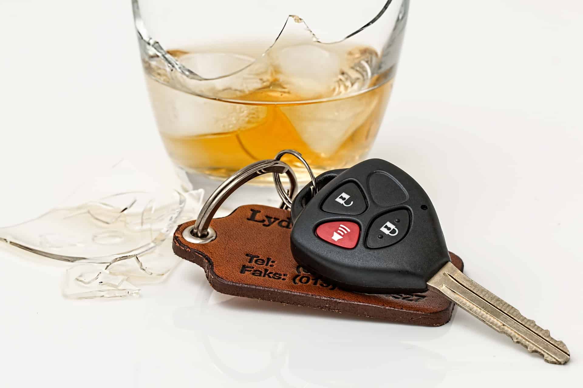glass of alcohol next to keys - drunk driving article